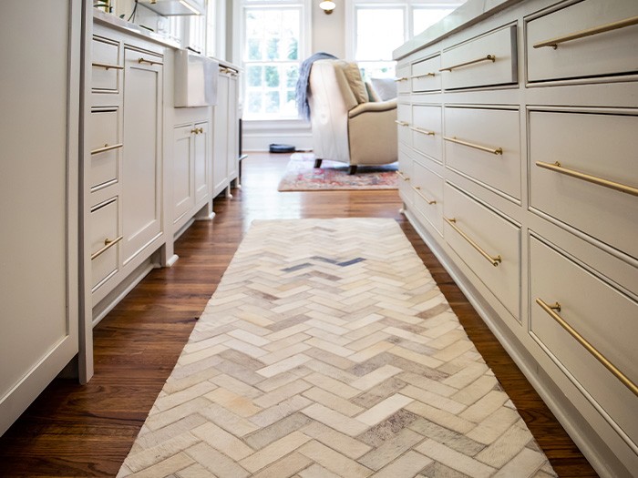 A runner rug in the kitchen cushions feet