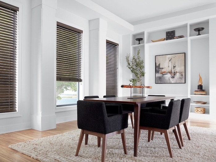A dining room with a textured area rug.