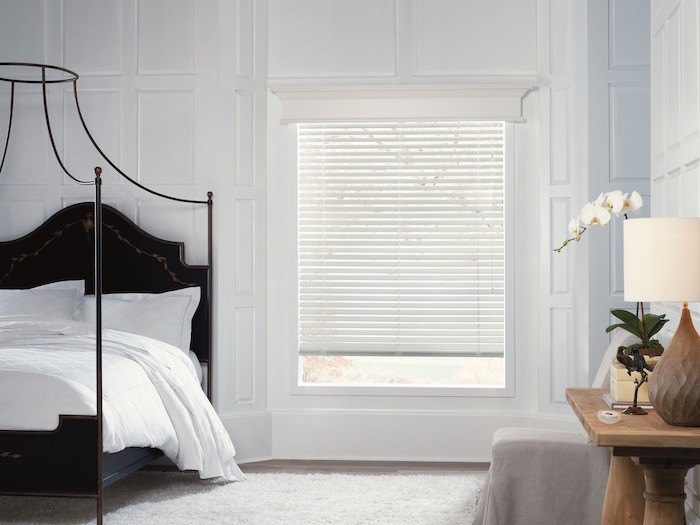 A canopy bed with a beautiful wooden headboard